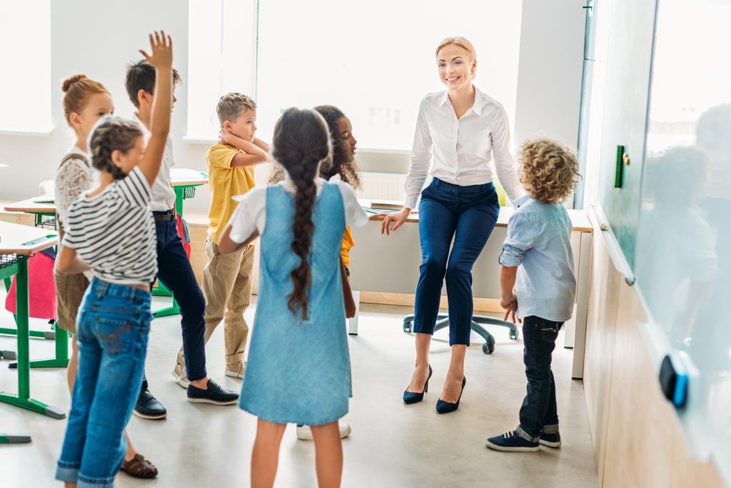 classmates standing around teacher