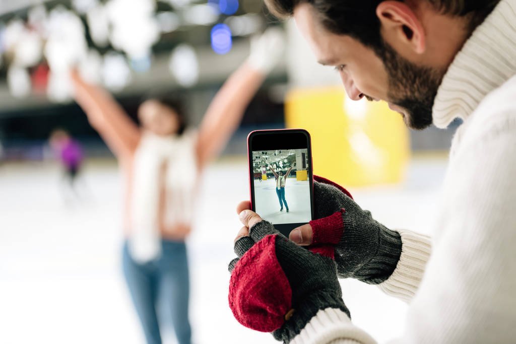 man taking photo of woman
